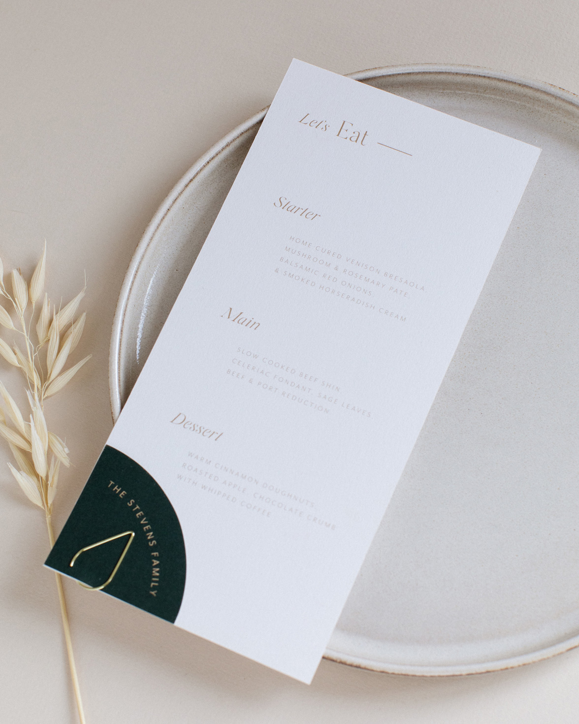 Refined gold wedding menu with digitally printed gold. Quarter circle shape guest name tag attached with a clip.