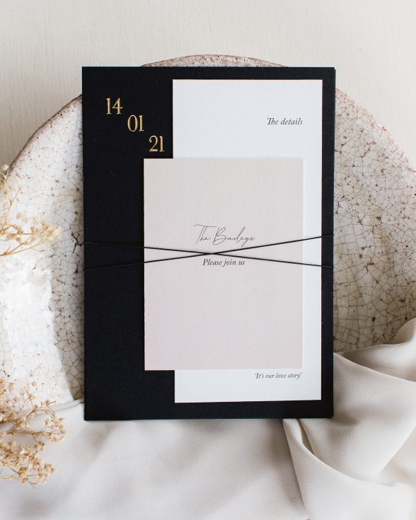 Black invitation with gold foil design. White details card and nude colour RSVP card tie with thin black twine together to create an invitation bundle