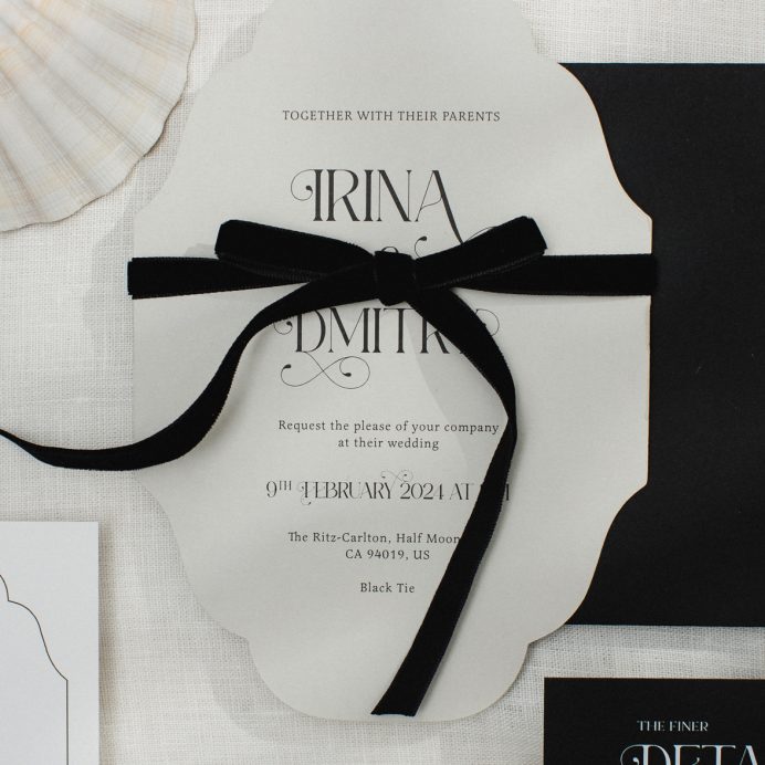 Vintage inspired cut to shape wedding invitation with ornate font and black velvet bow