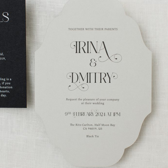 Vintage inspired cut to shape wedding invitation in grey with ornate font. black envelope