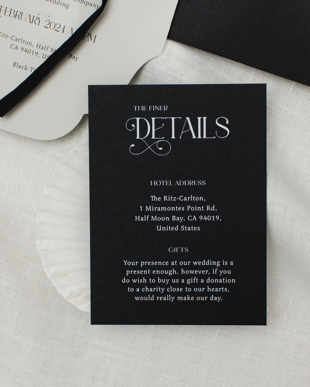Black and white wedding details card with ornate font