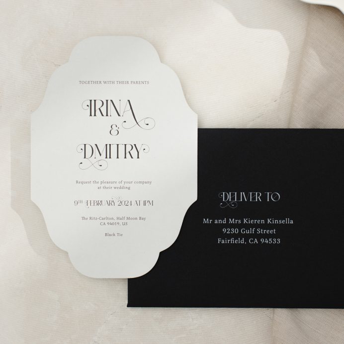 Vintage inspired cut to shape wedding invitation in grey with ornate font. black envelope