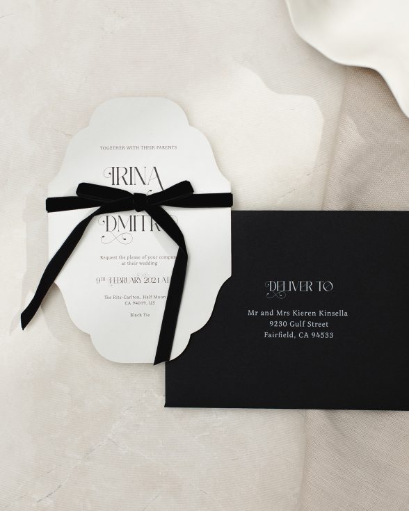 Vintage inspired cut to shape wedding invitation in grey with ornate font. black envelope