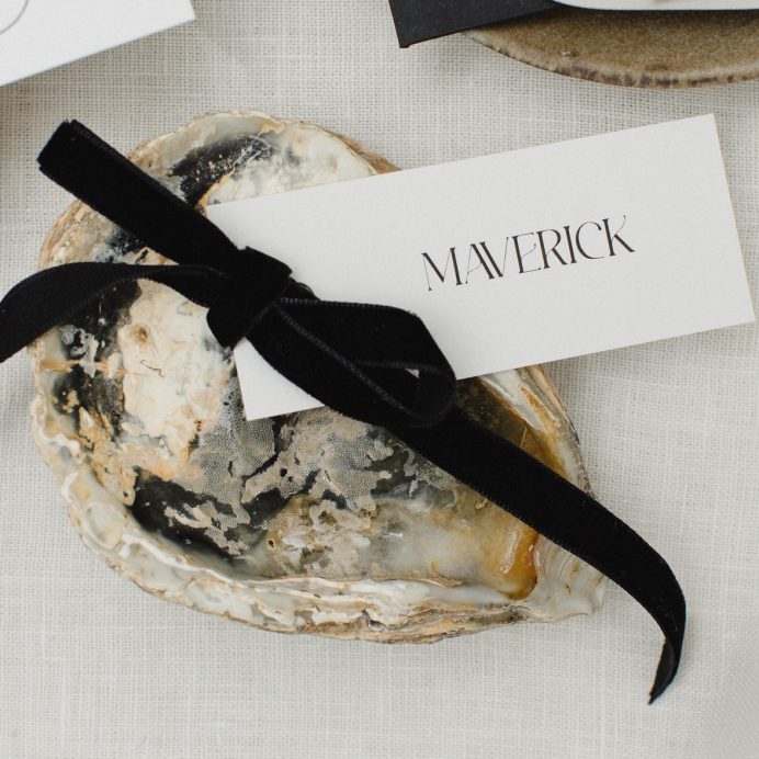 White guest name card with and black velvet bow.
