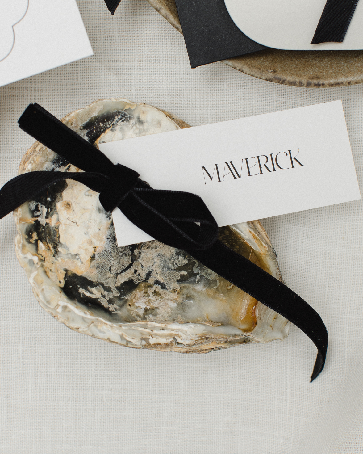 White guest name card with and black velvet bow.