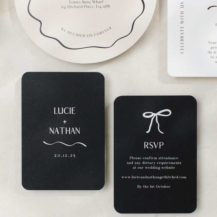 Black and white wedding RSVP card with rounded corners and hand drawn bow