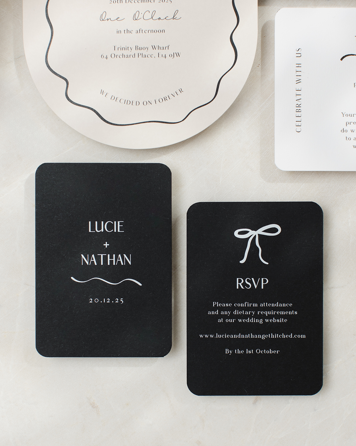 Black and white wedding RSVP card with rounded corners and hand drawn bow