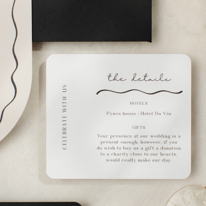 Black and white wedding details card with rounded corners and hand drawn bow