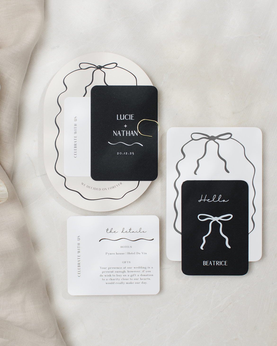 Double arch shape almond and black wedding stationery collection with hand drawn squiggly line border and bow.
