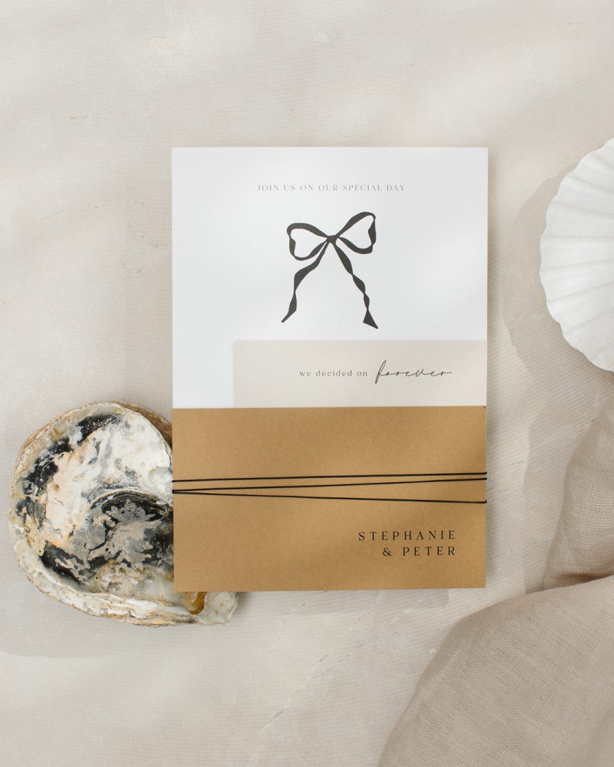 Black and white wedding invitation with bow. Mustard colour RSVP tied together with twine
