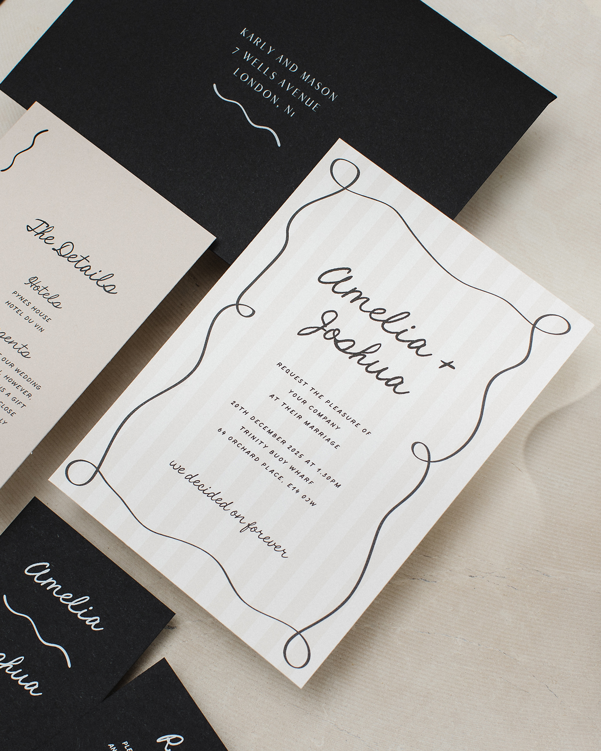 Tonal stripe wedding invitation with squiggly border and hand drawn font. Black envelope addressed with white ink