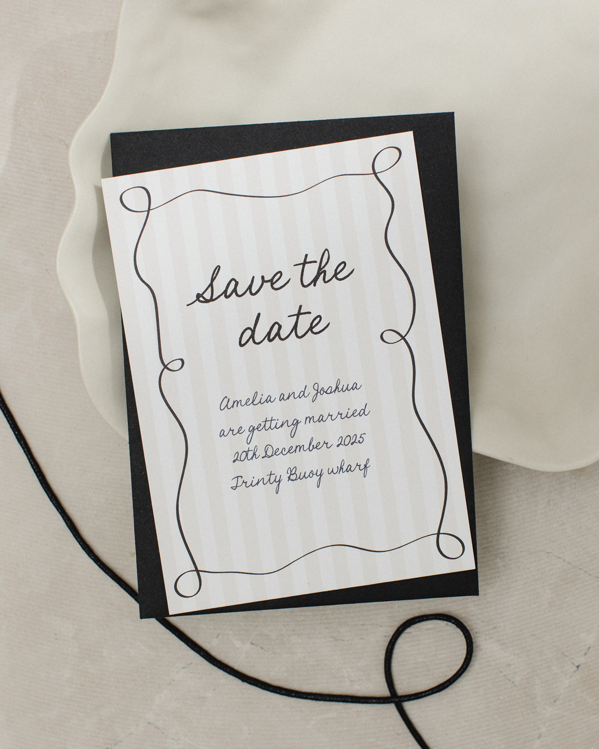 Tonal stripe wedding save the date with squiggly border and hand drawn font. Black envelope